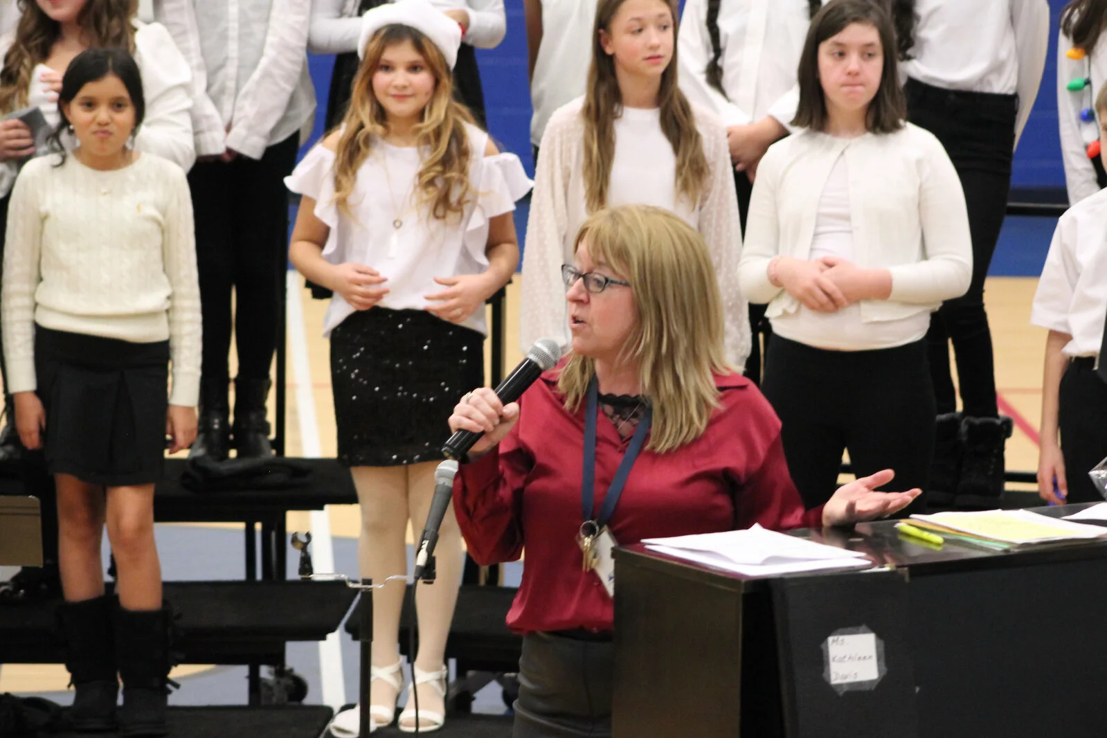 Choir director Kathleen Davis speaks at the concert